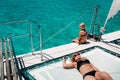 A girl and a child relax on a yacht in the Indian ocean near the island of Mauritius. Coral reef with turquoise water Royalty Free Stock Photo