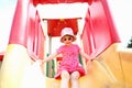 Girl child rolls down a hill in an amusement Royalty Free Stock Photo