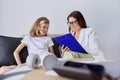 Girl child at session with female psychologist counselor social worker in office Royalty Free Stock Photo