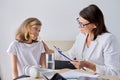 Girl child at session with female psychologist counselor social worker in office Royalty Free Stock Photo