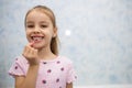 Girl child shows her mouth without one lost milk tooth and smiles Royalty Free Stock Photo