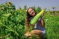 Girl child small farmer proud with harvest, garden background