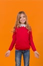 Girl child with smile in red sweater and blue jeans Royalty Free Stock Photo