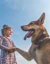 a girl, child summer Sunny day walking the dog on a leash, shepherd on a green grassy meadow Royalty Free Stock Photo