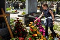 Girl child is throwing flower in grave of deceased person Royalty Free Stock Photo