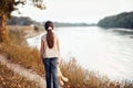 The girl child with toy bear walking along the path in the forest at sunset, beautiful river and landscape Royalty Free Stock Photo