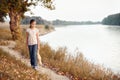 The girl child with toy bear walking along the path in the forest at sunset, beautiful river and landscape Royalty Free Stock Photo