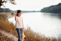 The girl child with toy bear walking along the path in the forest at sunset, beautiful river and landscape Royalty Free Stock Photo