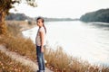 The girl child with toy bear walking along the path in the forest at sunset, beautiful river and landscape Royalty Free Stock Photo