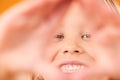 Girl child, triangle hands and studio portrait with smile, excited and sign language by yellow background. Female kid