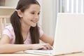 Girl Child Using Laptop Computer At Home Royalty Free Stock Photo