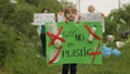 Girl volunteer holds protesting poster Say No To Plastic. Ecology trash nature pollution. Recycle
