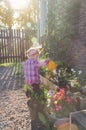 Child with a watering can on a Sunny day