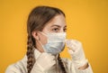 girl child wearing respirator mask to protect from coronavirus, safe Royalty Free Stock Photo