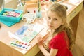 Girl child 7 years old, drawing watercolor at the table at home. Child creativity, recreation, development Royalty Free Stock Photo