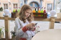 Girl child 9, 10 years old holding in hands and looking at screen of smartphone Royalty Free Stock Photo