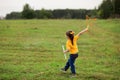 Girl Child 4-5 Years Old In A Yellow T-shirt And Jeans Blows Big Soap Bubbles, And They Burst
