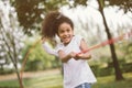 Girl children playing tug of war at the park