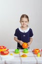 Girl with the children's kitchen utensils