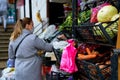 A girl chooses goods at a street vegetable counter