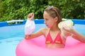 Girl chooses medical face mask or mask for scuba diving in pool