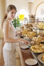 Girl chooses sweet meal Royalty Free Stock Photo