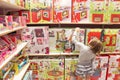 Girl chooses a toy in a toy shop