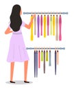 The girl is choosing colored garment on hangers. The woman in dress isolated on white background