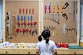 A girl is choosing tools on the table and board. Workshop scene concept