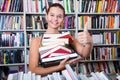 Girl chose a lot of books in university library Royalty Free Stock Photo