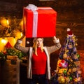 Girl with christmas gift box. Girl with christmas hat and many gifts celebrating the christmas holidays having big box Royalty Free Stock Photo