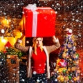 Girl with christmas gift box. Girl with christmas hat and many gifts celebrating the christmas holidays having big box Royalty Free Stock Photo