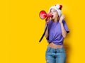 Girl in Christmas hat with pink megaphone