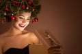 Girl with christmas wreath on her head. Open magic gift box Royalty Free Stock Photo