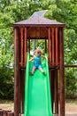 Girl chuting down slide at playground Royalty Free Stock Photo