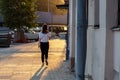 Girl with a cigarette walks on a city street