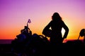 Girl and classic motorcycle at sunset Royalty Free Stock Photo
