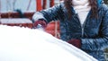 Girl cleaning car from snow. Clean car window from snow. Winter windshield car cleaning. Removing snow from window