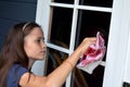 Girl cleaning windows Royalty Free Stock Photo