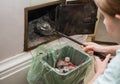 Girl cleans the fireplace from ash