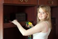 Girl cleans furniture at home