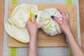 Girl cleans a pomelo on a wooden board Royalty Free Stock Photo