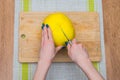 Girl cleans a pomelo on a wooden board Royalty Free Stock Photo