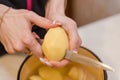 The girl cleans the potatoes. Cooking at home. Natural products. Cooking a dish of potatoes Royalty Free Stock Photo