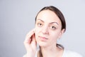 Girl Cleansing her Face Using Cotton with Cleanser Royalty Free Stock Photo