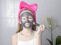 Girl with a cleansing mask on her face. Home skin care Royalty Free Stock Photo