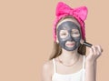 Girl with a cleansing mask on her face. Home skin care Royalty Free Stock Photo