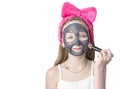 Girl with a cleansing mask on her face. Home skin care Royalty Free Stock Photo