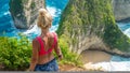 Girl on Cliff at Manta Bay or Kelingking Beach, Nusa Penida Island, Bali, Indonesia Royalty Free Stock Photo