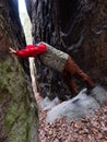 Girl climb for fun between rocks. Natural thin pass Royalty Free Stock Photo